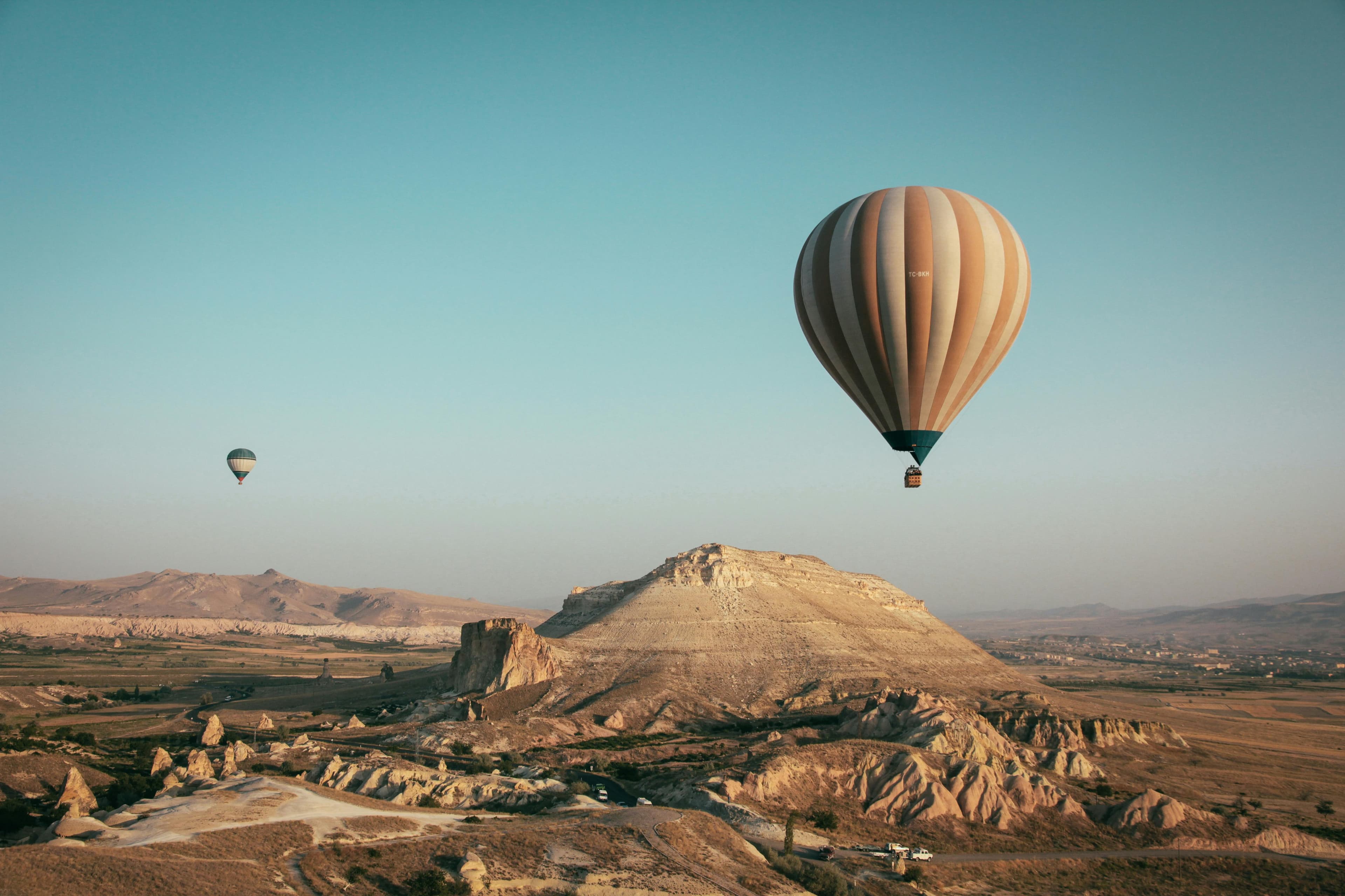 Hot air balloons over desert landscape